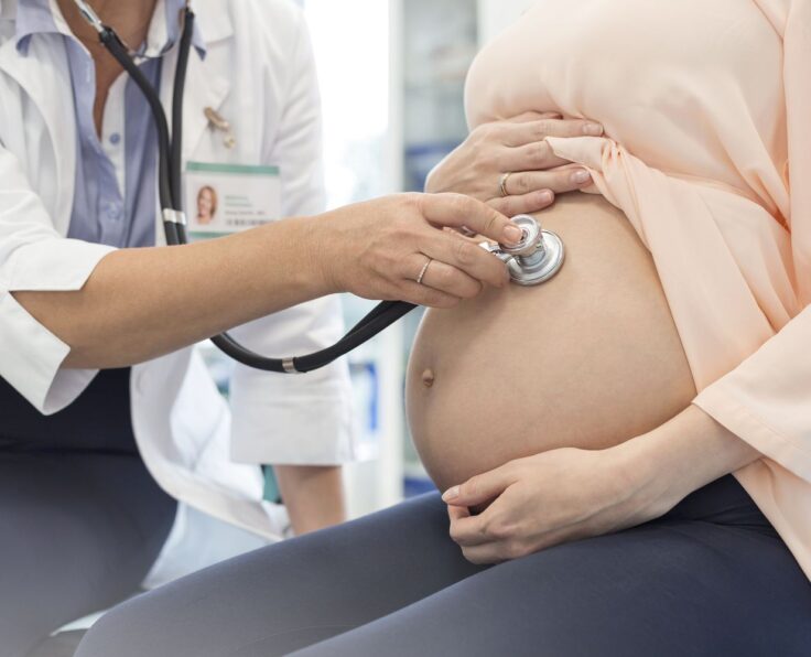 doctor-using-stethoscope-on-pregnant-patients-stomach-595348651-59932a7968e1a2001113f56d